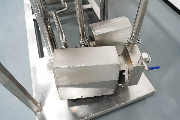 Supply and return pumps on the base frame, clamped pipework and a drain point at the low corner.